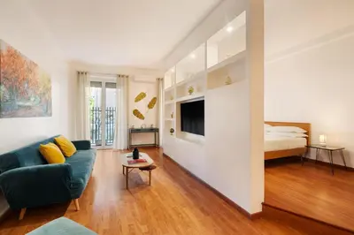 a living room with a couch and a bed at Lungotevere Trastevere Loft in Rome