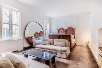 a living room with a couch and a mirror at EVA Loft in Rome