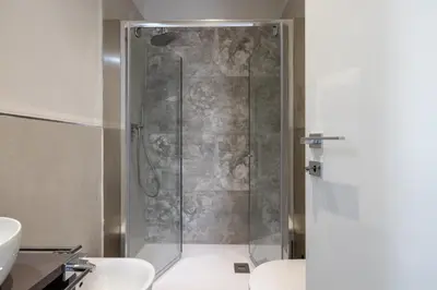 a shower stall in a bathroom with two toilets at Belli San Giovanni Guest House in Rome