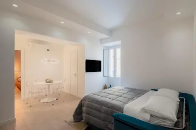 a bedroom with a bed and a table in a room at Giulio Cesare Flat - VATICAN in Rome
