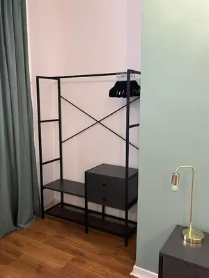 a black shelf with a dresser and a lamp at RiversideMellini44 in Rome