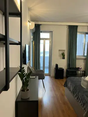 a bedroom with a bed and a desk with a plant at RiversideMellini44 in Rome