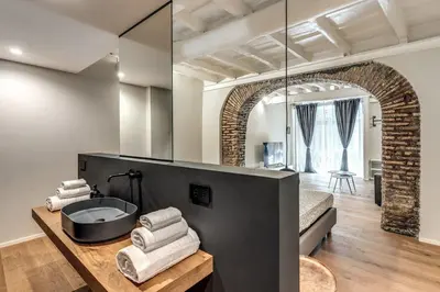 a bathroom with a bath tub and a mirror at Vicolo Orsoline Piazza Spagna in Rome