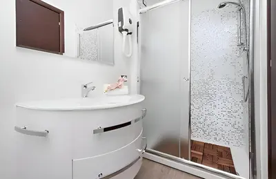 a bathroom with a sink and a shower at Ungaretti Vatican Apartment in Rome