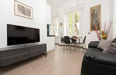 a living room with a couch and a tv at Ungaretti Vatican Apartment in Rome