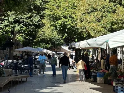 a group of people walking through an outdoor market at Roma, Città degli Uomini in Rome