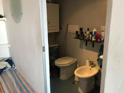 a small bathroom with a toilet and a sink at Roma, Città degli Uomini in Rome
