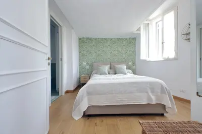 a white bedroom with a bed and a window at Montevecchio2 in Rome