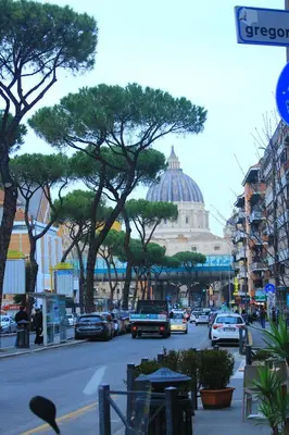a busy city street with cars parked on the road at Soggiorni Romani in Rome