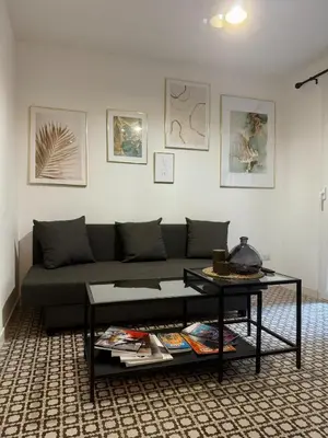 a living room with a couch and a table at Monti Cozy Apartment in Rome