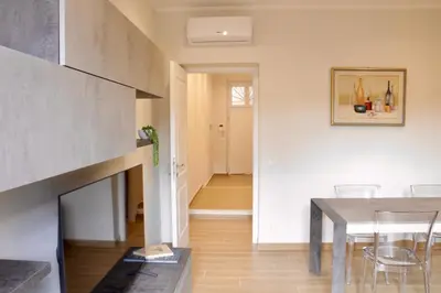 a living room with a table and a fireplace at HC - Miriam's Brand New Apartment in Vatican in Rome