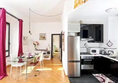 a kitchen and dining room with a table and chairs at LoL-ApartmenT, in the heart of Trastevere in Rome