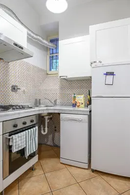 a kitchen with white appliances and a white refrigerator at Casa Aventino in Rome