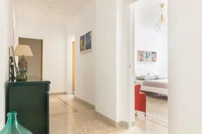 a living room with a green cabinet and a bedroom at Family Rooms in Rome