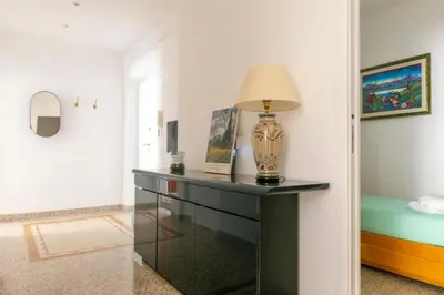 a room with a table with a lamp on it at Family Rooms in Rome