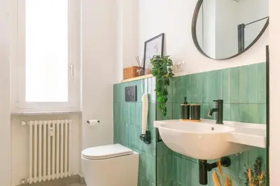 a bathroom with a sink and a toilet and a mirror at Family Rooms in Rome