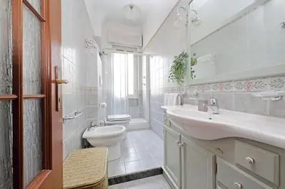 a white bathroom with a sink and a toilet at Casa Giannetta in Rome