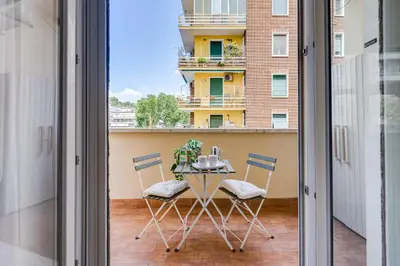 a table on a balcony with two coffee mugs at Boutique Apartment in Vatican in Rome