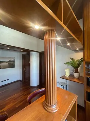 a dining room with a table with a column at Rome Opera Theatre Rooms by Dama - Termini Station & Rome City Center in Rome
