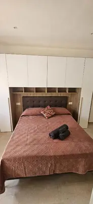 a bed with two black shoes on top of it at Anastasio Terrace double 3 in Rome