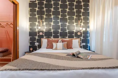 a bedroom with a bed with a large headboard at Giardino Privato & Comfort - Oasi di Relax a Roma in Rome