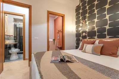 a bedroom with a large bed and a bathroom at Giardino Privato & Comfort - Oasi di Relax a Roma in Rome