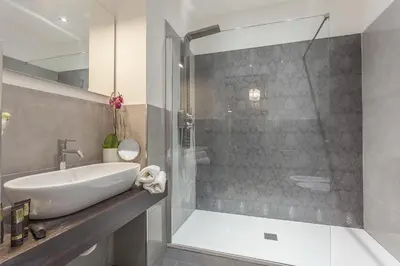 a bathroom with a sink and a shower at St. George's Vatican Suites in Rome