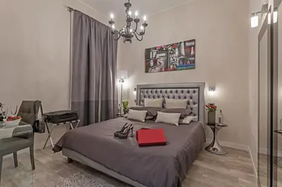 a bedroom with a bed with a red box on it at St. George's Vatican Suites in Rome