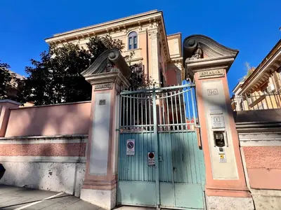 a house with a blue door and a fence at Amalia Vatican House in Rome