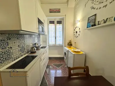 a kitchen with white cabinets and a counter top at Satrico43 - San Giovanni Stay in Rome