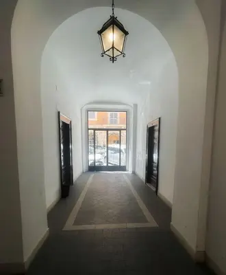 an empty hallway with a chandelier in a building at Testaccio Stay - your home in the heart of Rome in Rome