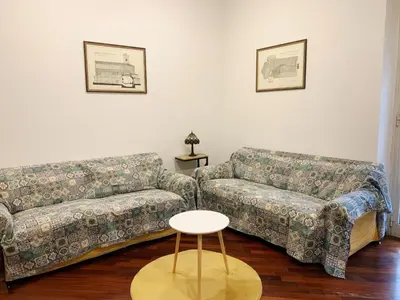a living room with two couches and a table at Peck House in Marconi San Paolo in Rome