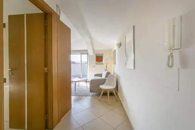a hallway with a door and a chair in a room at Terrazza San Pietro vicino metro A in Rome