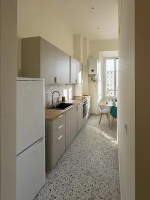 a kitchen with white cabinets and a sink at Colosseum Charme in Rome