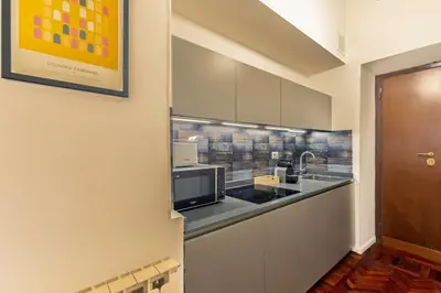 a kitchen with a sink and a microwave at Domus Flavia Monti in Rome