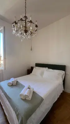 a bedroom with a large white bed with towels on it at Dome View in Rome