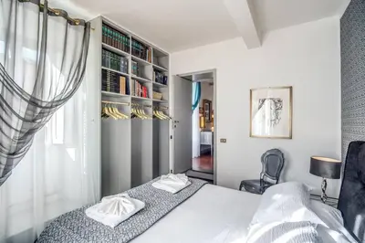 a bedroom with a bed and a book shelf at Navona, 3 bedrooms, unique and spectacular view in Rome