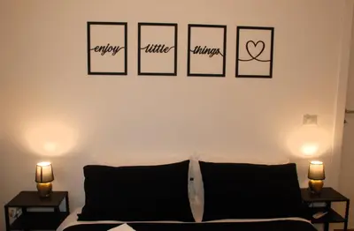 a bedroom with four pictures on the wall at Viva la vida in Rome in Rome