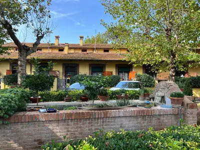a house with cars parked in front of it at Apartment in green oasis in Rome