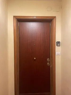 a wooden door in a room with aperatureperatureensityensity at Dama Maria Elena - 1 min walk to Valle Aurelia Metro in Rome