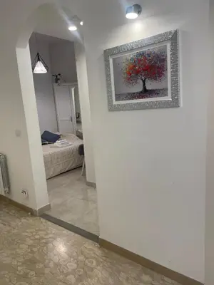 a room with a painting of a tree on the wall at Dama Maria Elena - 1 min walk to Valle Aurelia Metro in Rome