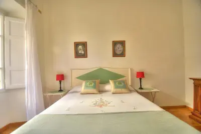 a bedroom with a large bed with two lamps at Via Veneto Cosy House in Rome