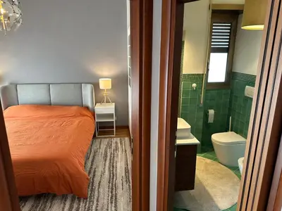 a bedroom with a bed and a bathroom with a toilet at La dolce vita in Rome - Guest House in Rome