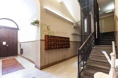a hallway of a building with stairs and a door at Hostly-The Porta Pia Suite-Rome Centre with Charme in Rome