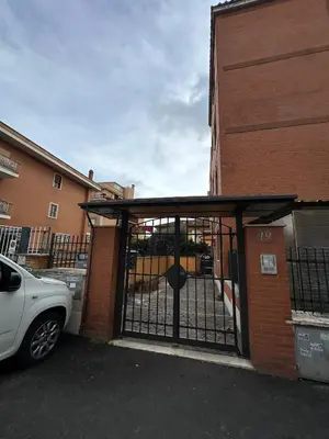 a car parked in front of a building with a gate at Il Nido di Roma - Ospedale Gemelli & Garden in Rome