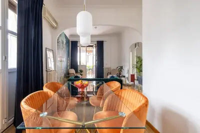 a dining room with a glass table and chairs at Elegant Penthouse with Terrace in Rome