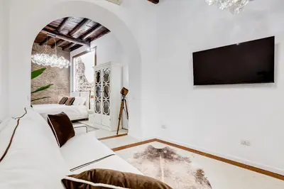a living room with white furniture and a flat screen tv at NEW ROMAN Apartment - Rome Dream Home in Rome