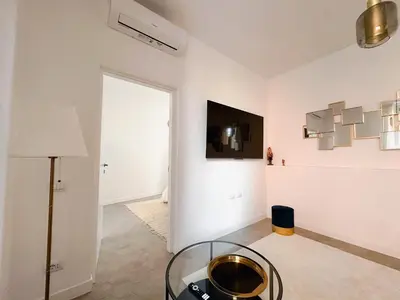 a living room with a glass table in a room at Lussuosa Casa nel cuore di Trastevere in Rome