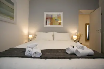 a bedroom with a white bed with towels on it at Thebestinrome Piazza del Popolo - Vico in Rome