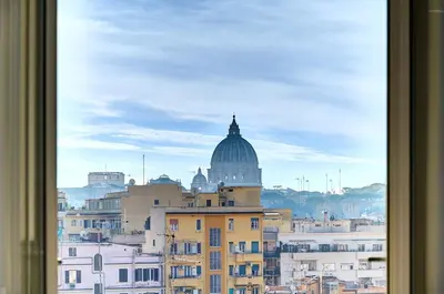 a view of a city from a window at Luxury view on St Peter Basilica in Rome